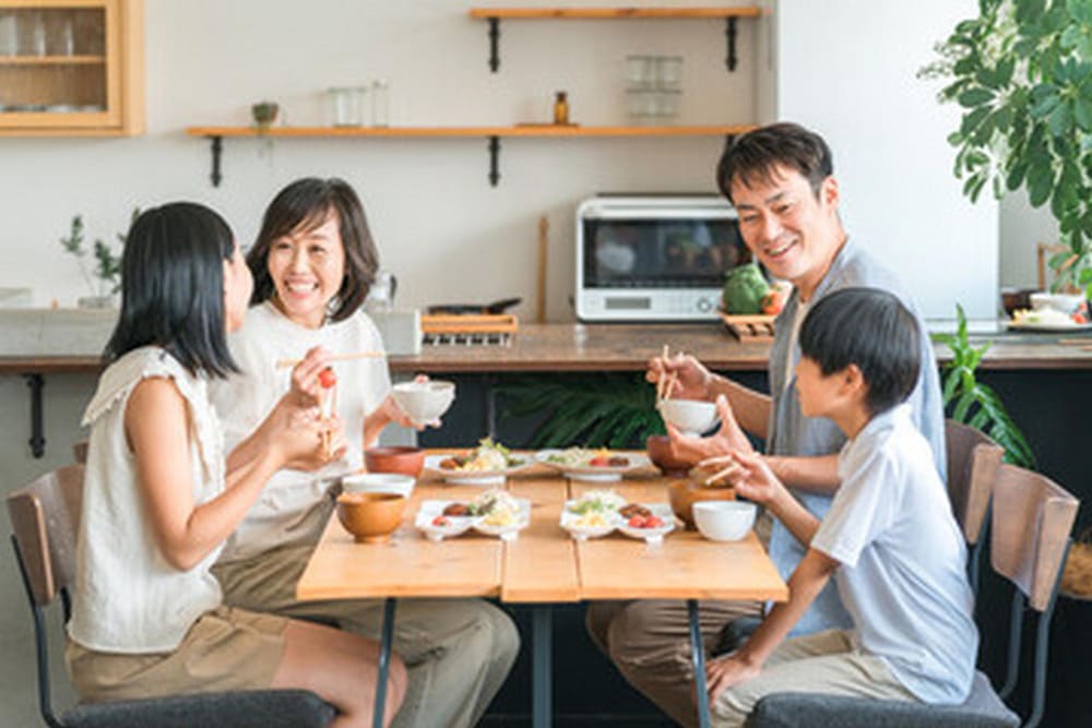 家族団らんで楽しい話をしながら夕食を食べている。